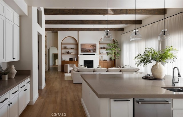 kitchen with sink, white cabinetry, decorative light fixtures, and dark hardwood / wood-style floors