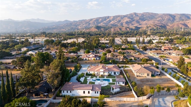 birds eye view of property with a mountain view