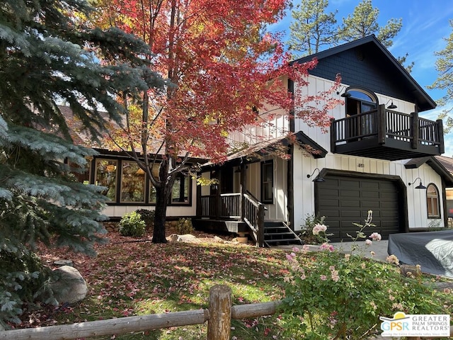 view of front of property featuring a garage and a balcony