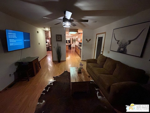 living room with light wood-type flooring and ceiling fan