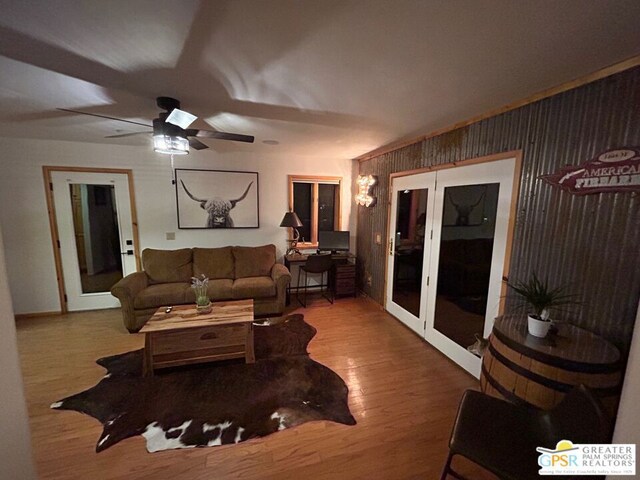 living room featuring hardwood / wood-style flooring and ceiling fan