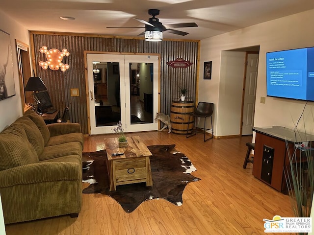 living room with light hardwood / wood-style floors, french doors, and ceiling fan