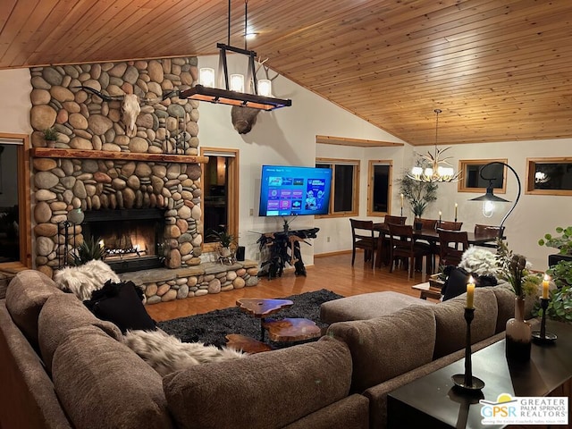 living room with wood ceiling, hardwood / wood-style floors, an inviting chandelier, high vaulted ceiling, and a fireplace