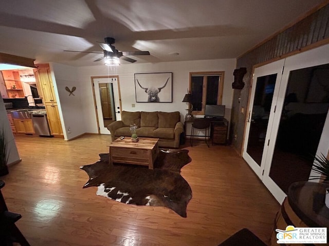 living room with light wood-type flooring and ceiling fan