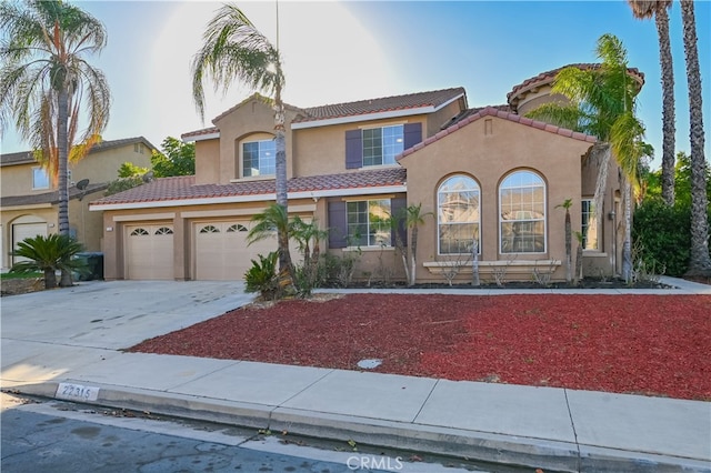 mediterranean / spanish home with a garage