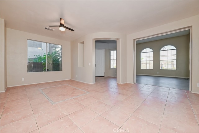 spare room featuring light tile patterned floors and ceiling fan