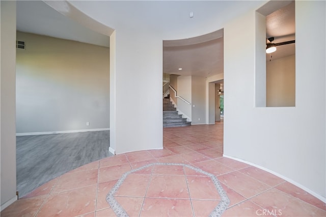 unfurnished room with ceiling fan and tile patterned floors