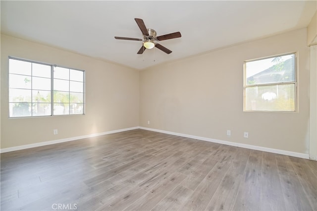 empty room with light hardwood / wood-style flooring and ceiling fan