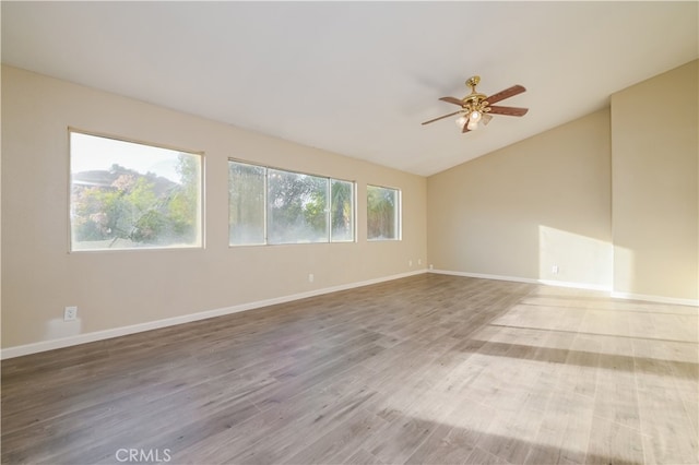 spare room featuring lofted ceiling, hardwood / wood-style floors, and ceiling fan