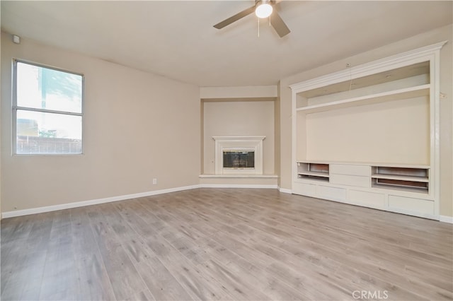 unfurnished living room with light hardwood / wood-style flooring and ceiling fan