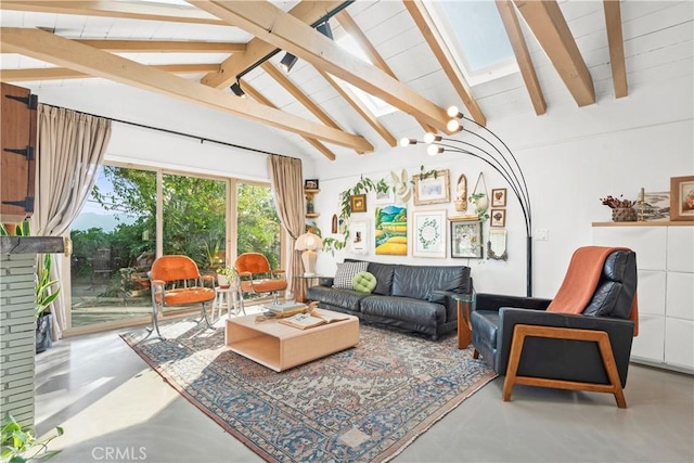 interior space featuring a fireplace, lofted ceiling with beams, and a notable chandelier