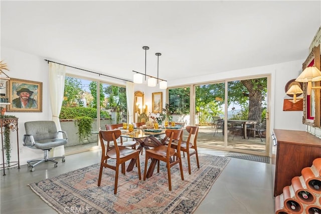 dining room with a healthy amount of sunlight and concrete floors