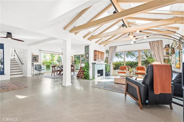 sunroom featuring vaulted ceiling with beams and ceiling fan