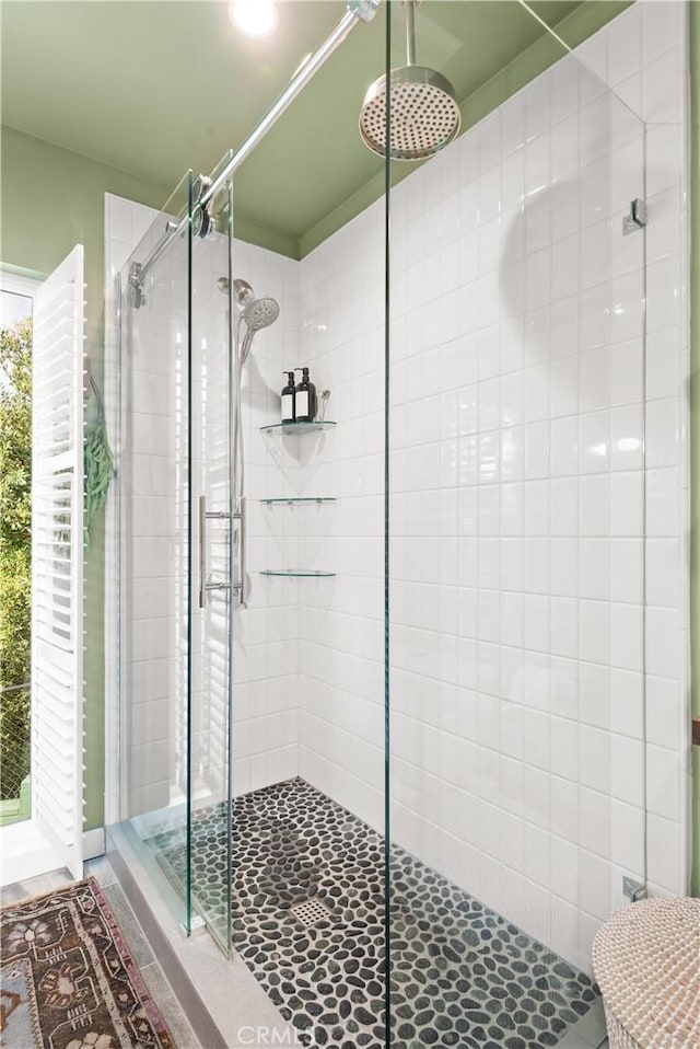 bathroom featuring tile patterned floors and a shower with door