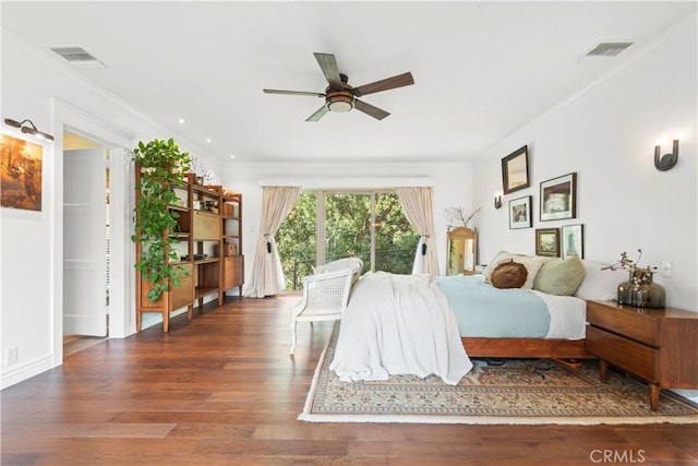 bedroom with ceiling fan, dark wood-type flooring, and ornamental molding