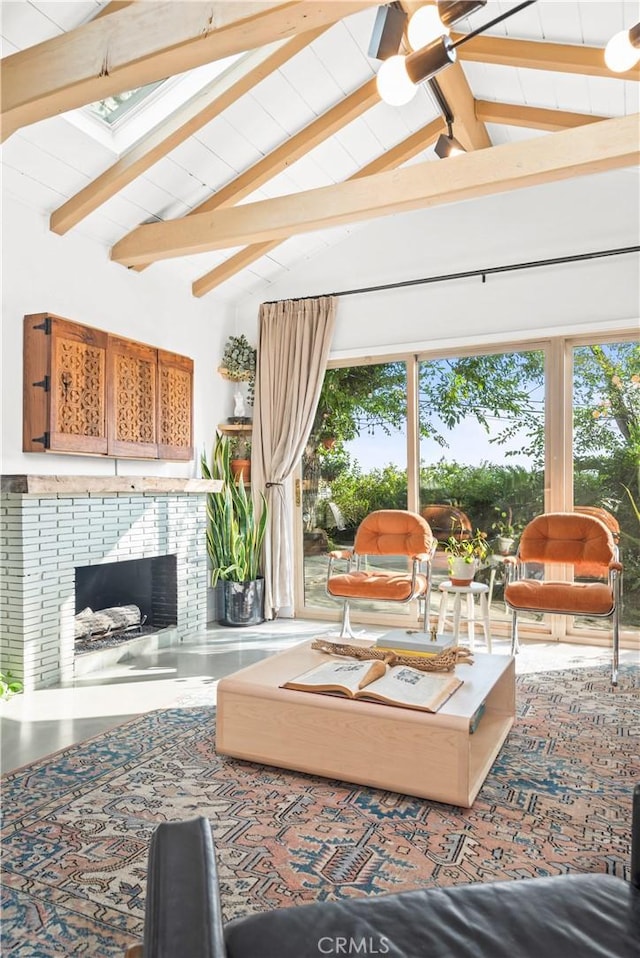 living room featuring beam ceiling, a fireplace, and high vaulted ceiling