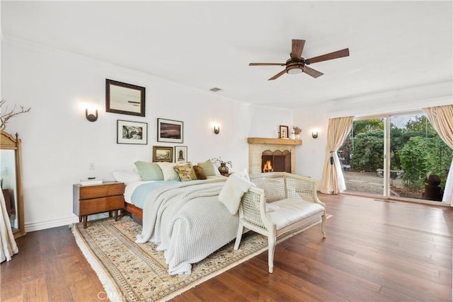 bedroom featuring hardwood / wood-style flooring, ceiling fan, ornamental molding, and access to outside