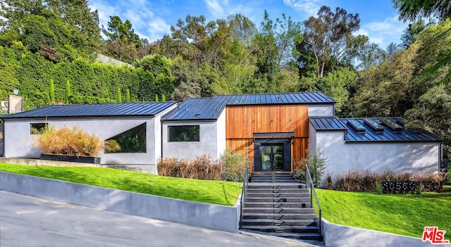 contemporary home featuring a front yard