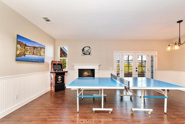 playroom featuring french doors, a chandelier, and dark hardwood / wood-style floors