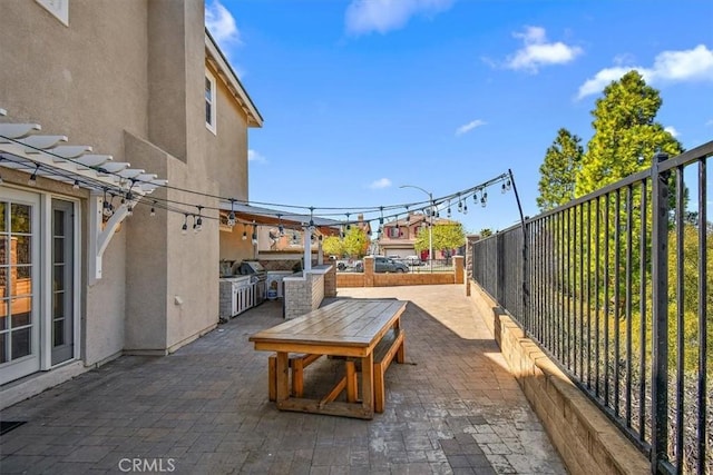 view of patio / terrace featuring a grill and an outdoor kitchen