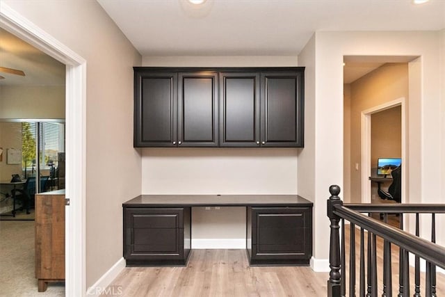 office featuring built in desk and light hardwood / wood-style flooring