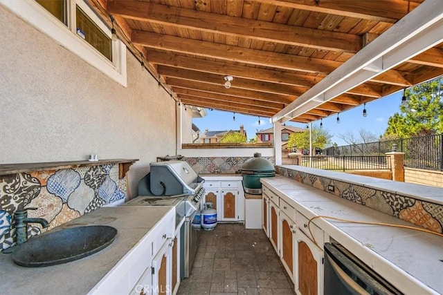 view of patio with a grill, sink, and exterior kitchen