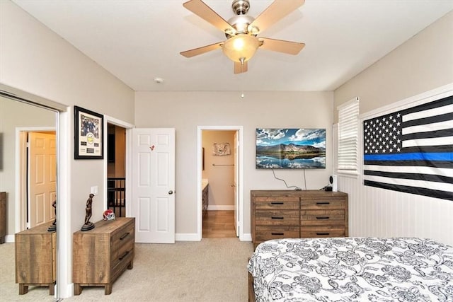 carpeted bedroom featuring ceiling fan and ensuite bathroom