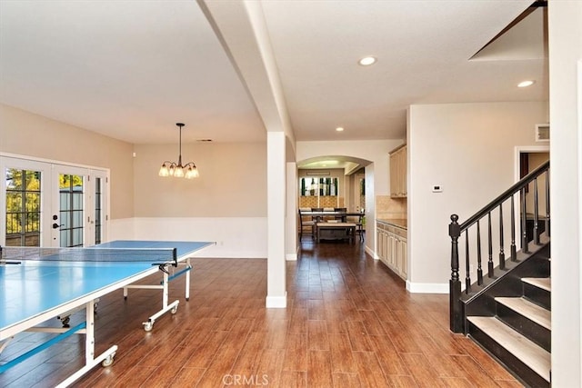 playroom featuring hardwood / wood-style floors, a chandelier, and french doors