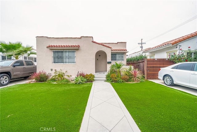 mediterranean / spanish house with a front lawn