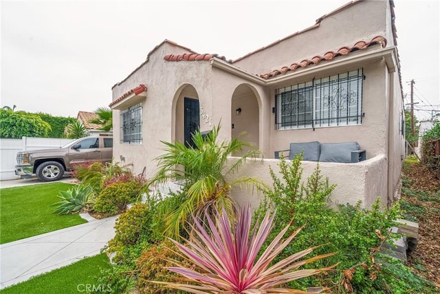 mediterranean / spanish house featuring a front yard