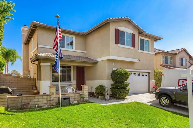 view of front of home with a front lawn and a garage