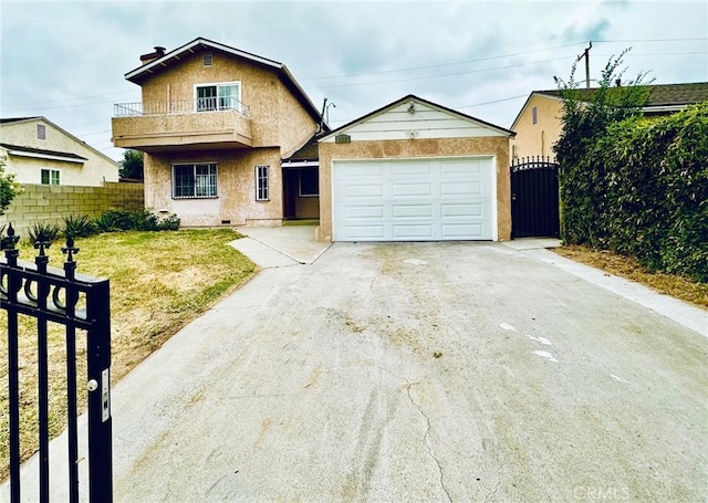 view of front of property featuring a balcony, a front lawn, and a garage