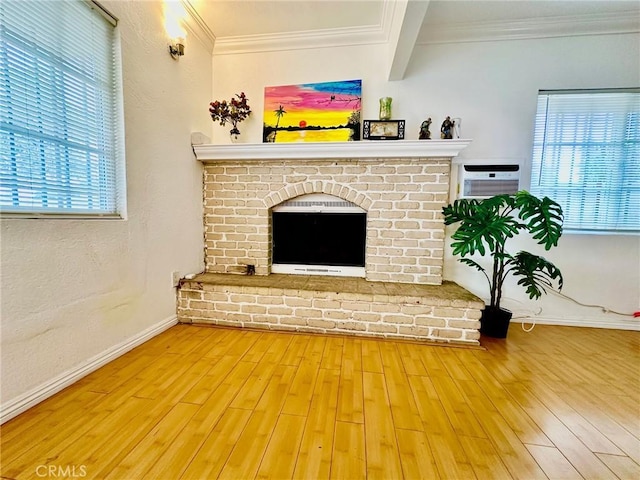 living room featuring a brick fireplace, ornamental molding, beam ceiling, wood-type flooring, and a wall unit AC