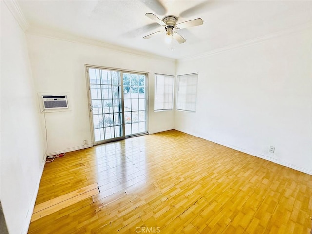 empty room with crown molding, ceiling fan, light hardwood / wood-style floors, and a wall mounted air conditioner