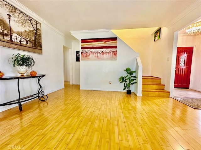 foyer entrance with hardwood / wood-style flooring and ornamental molding