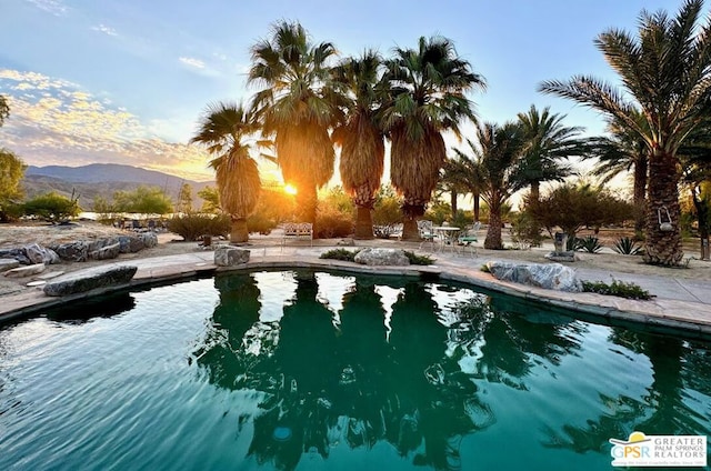 pool at dusk with a mountain view