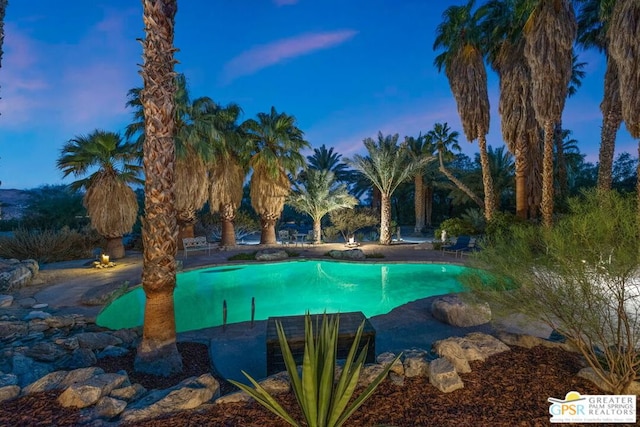 view of pool at dusk