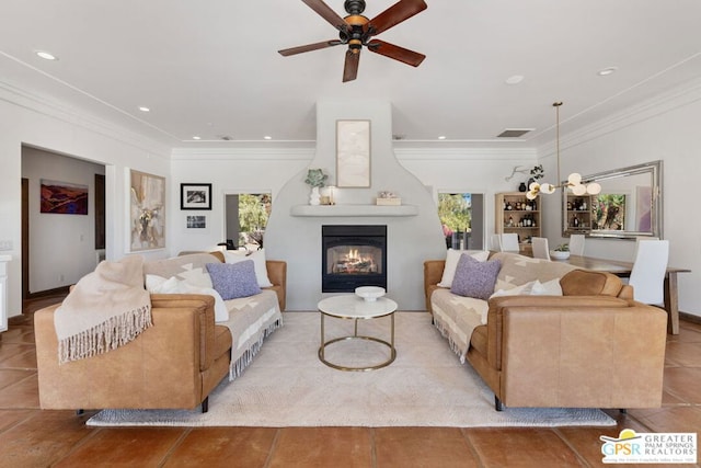 tiled living room with ornamental molding, a large fireplace, and a healthy amount of sunlight