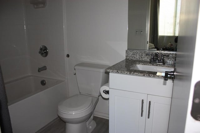 full bathroom with hardwood / wood-style flooring, shower / washtub combination, vanity, and toilet