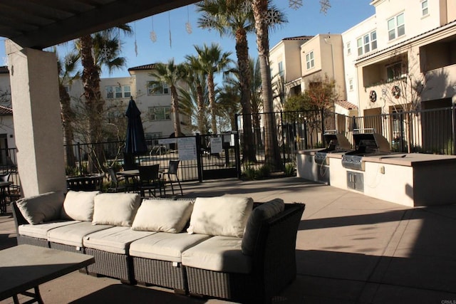 view of patio featuring grilling area, an outdoor living space, and exterior kitchen