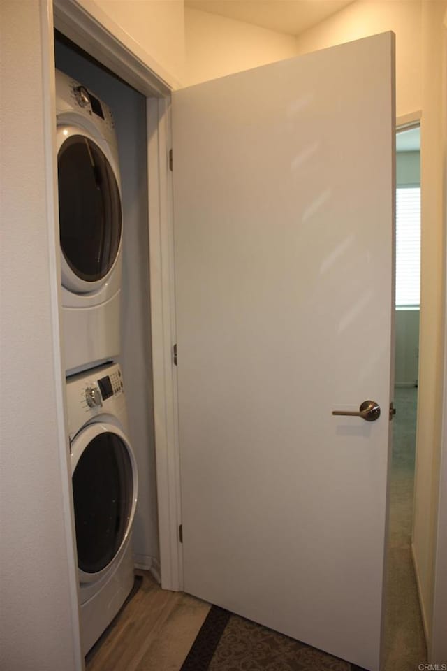 laundry room with stacked washer / dryer