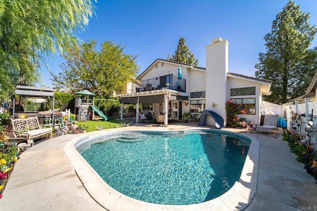 view of pool with a patio and a playground