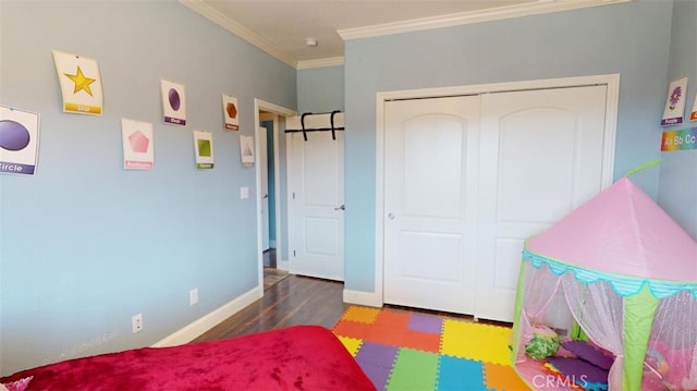 bedroom featuring a closet, ornamental molding, and dark hardwood / wood-style flooring