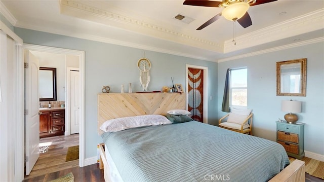 bedroom with ceiling fan, crown molding, and a tray ceiling