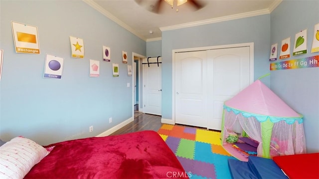 bedroom featuring a closet, ceiling fan, crown molding, and dark wood-type flooring