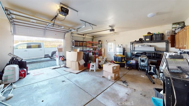 garage featuring a garage door opener and white refrigerator