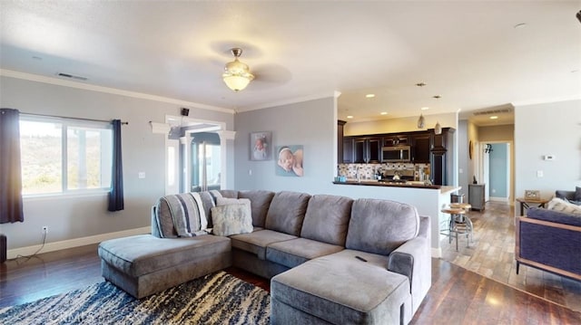 living room featuring ceiling fan, crown molding, and dark hardwood / wood-style flooring