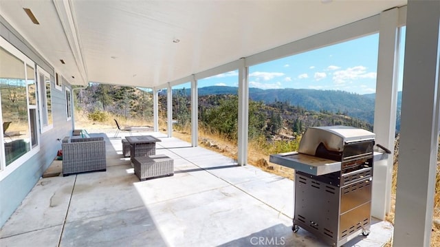 view of patio / terrace featuring a mountain view and a grill