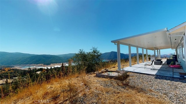 view of yard with a patio and a mountain view