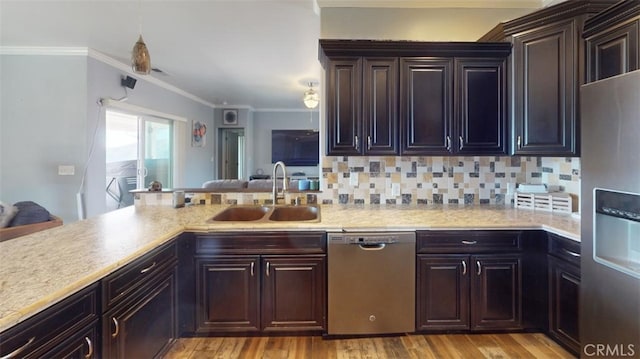 kitchen with kitchen peninsula, stainless steel appliances, sink, crown molding, and light hardwood / wood-style floors